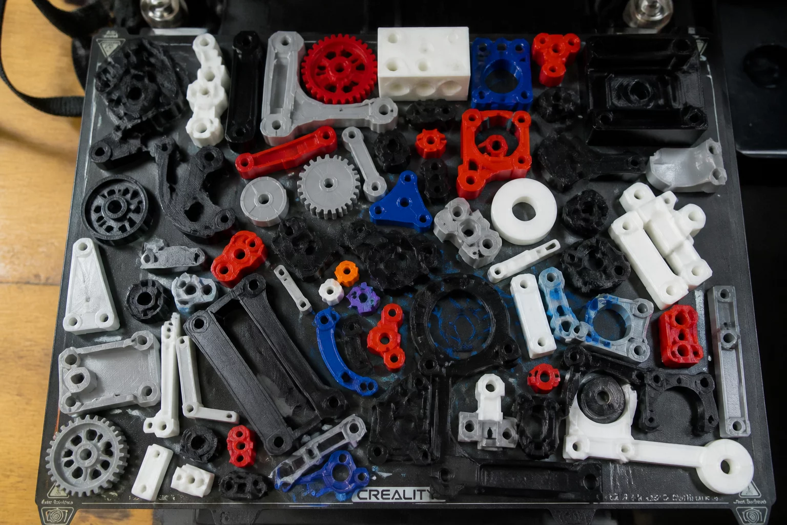 Overcrowded 3D printer build plate with parts tightly nested demonstrating workflow confusion